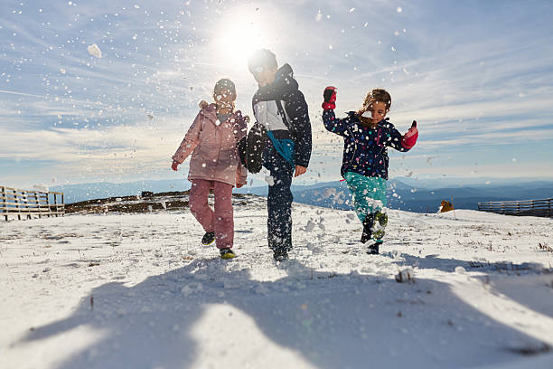 istock Happy kids enjoying winter snow 2220595065