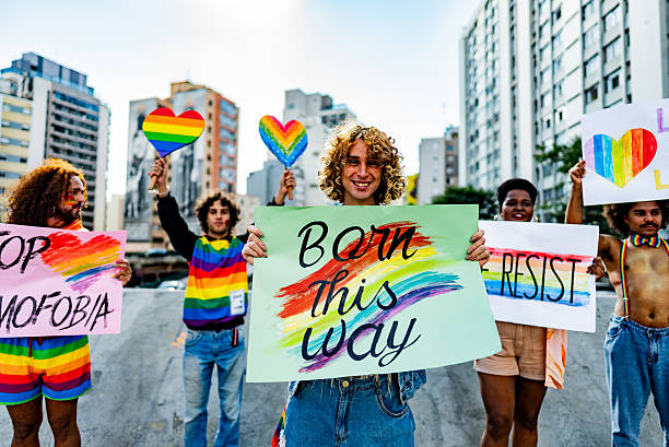 istock Transgender activist holding 'Born This Way' sign during LGBTQ+ pride protest 2220596124
