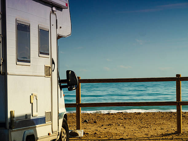 istock Rv motor home camping on beach 2220596301
