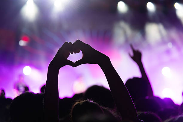 istock Hands making heart shape at music festival 2220597764