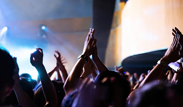 istock People clapping hands at music festival 2220597796