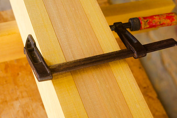 Close=up pf c-clamps at wood in capentry