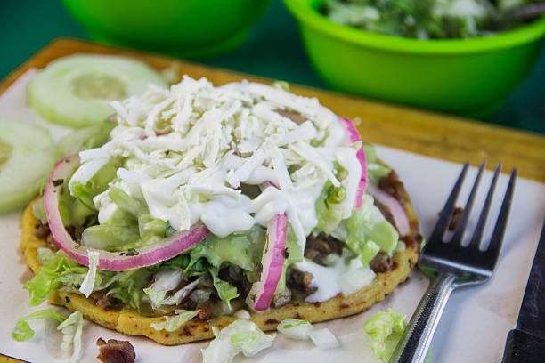 istock An inviting chicken sope generously garnished with fresh greens and creamy sauces, elegantly presented on a wooden board, ideal for food lovers seeking vibrant flavors. 2220599466
