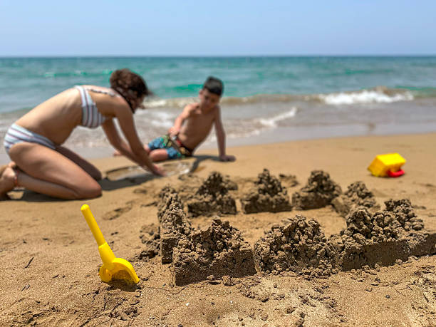istock Family having fun on the beach 2220599909