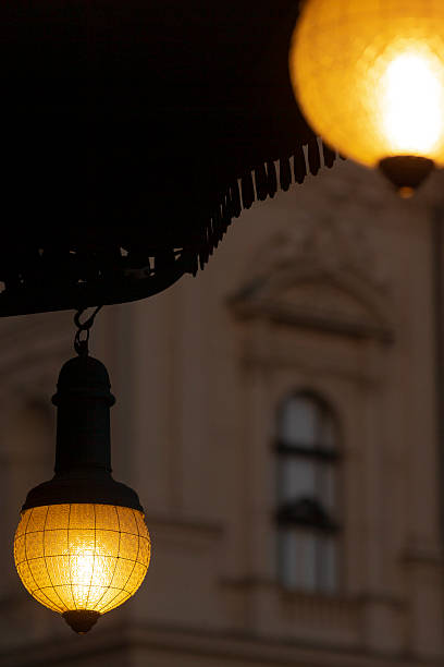 istock Street Lanterns Illuminated at Dusk with an Architectural Backdrop 2220599993