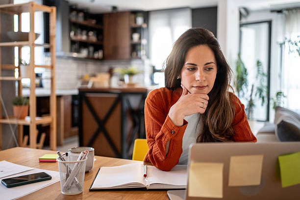 istock Focused businesswoman working from home using laptop computer 2220600104