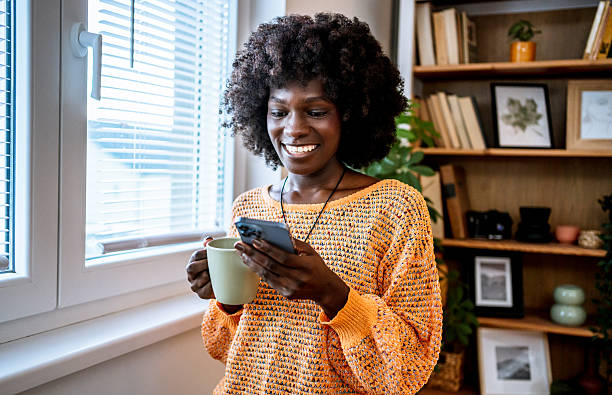 istock Young woman enjoying a coffee break and browsing her phone 2220603459