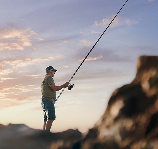 Fisher man rock sea rod sunrise