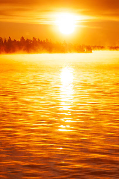 Fog over tranquil lake in Algonquin Provincial Park in early morning