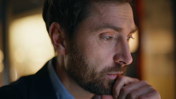 istock Closeup thoughtful employee working overtime creating project. Freelancer typing 2220610691