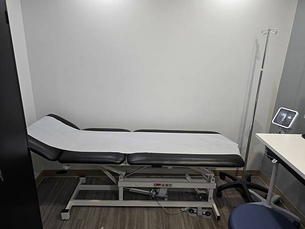 istock Modern Medical Examination Room with Adjustable Exam Table 2220610771