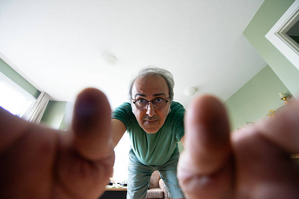 A Man Reaching to Adjust a Smart Digital Thermostat or Touch Screen Smart Home Device, from Unique POV of Device