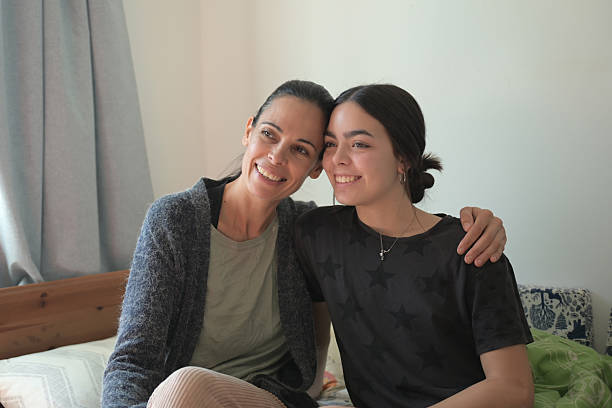 istock mom with her daughter sitting  smiling 2220612152