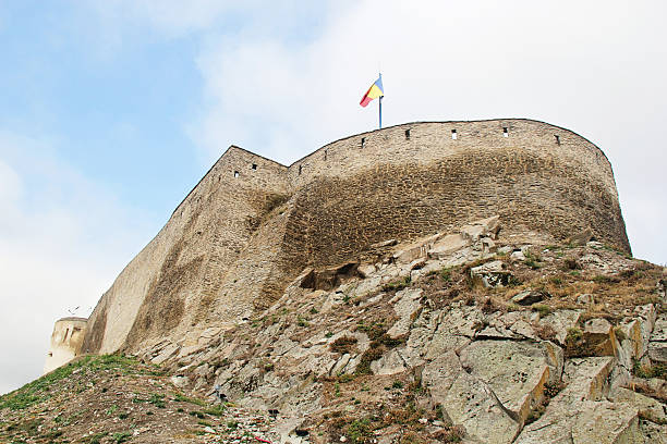 Deva, Romania - September 27 2019: Deva Fortress in Romania with Romanian Flag
