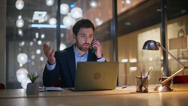 istock Professional consultant talking cellphone at corporate coworking space closeup. 2220616072