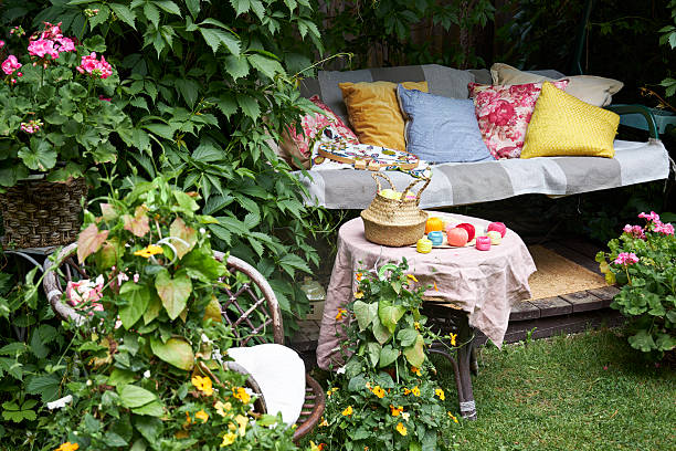 istock A cozy outdoor corner for creativity in a summer garden: a cushioned swing serves as a relaxing seat for embroidery, surrounded by lush greenery and flowers. Nearby stands a small table with colorful threads, fabric, and embroidery tools. The scene captur 2220616319