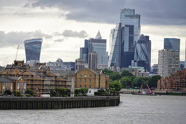 London, UK – June 4, 2025: A panoramic view of the urban skyline of East London, featuring a blend of modern skyscrapers and historic residential architecture of Rotherhithe. The skyline includes landmark buildings of the Financial District (Square Mile), such as 20 Fenchurch Street (the \
