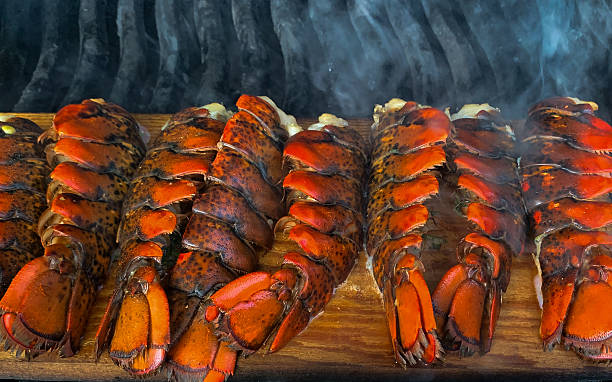 istock Grilled lobster tails on cedar plank 2220619160