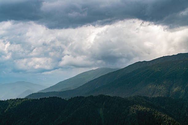 istock Scenic Mountain Landscape with Dense Forests and Dramatic Cloudy Sky 2220620756