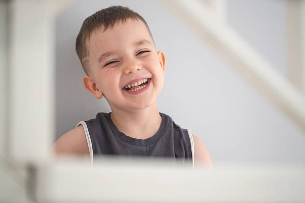 Close-up Portrait of Joyful Young Boy Indoors With a Cheerful and Playful Expression