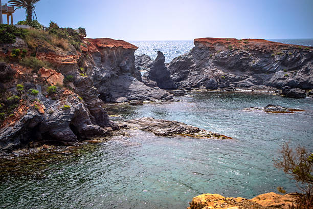Cala Botella on the rocky coast of Cabo de Palos, Cartagena, Region of Murcia, Spain