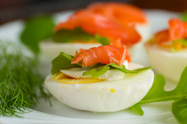 istock Boiled eggs with pieces of fish and herbs on top 2220623232