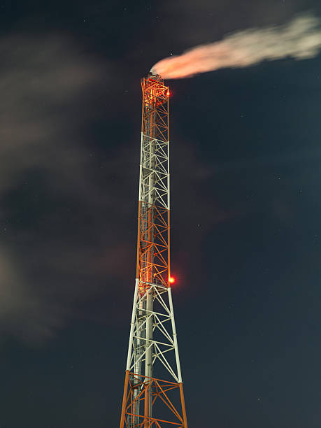 istock oil refinery at night with smoke 2220628472