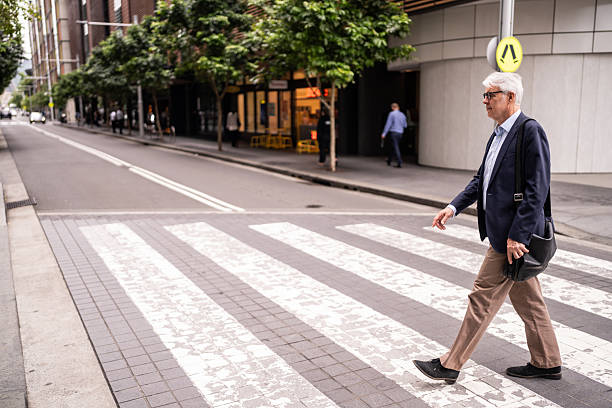 istock Mature Executive Walking Across Crosswalk in Sydney 2220629180