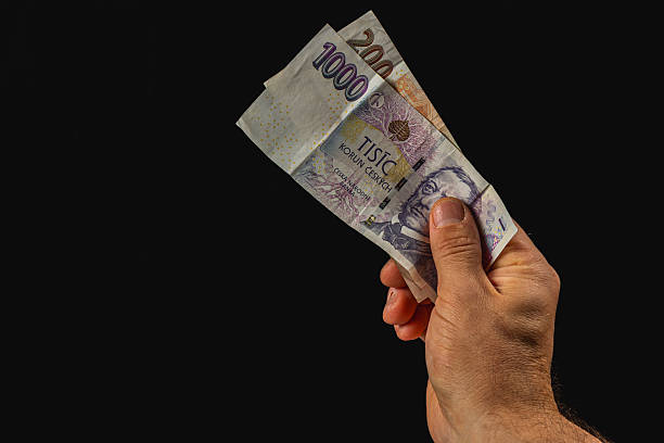 istock Hand holding cash in dark setting shows monetary exchange 2220634811