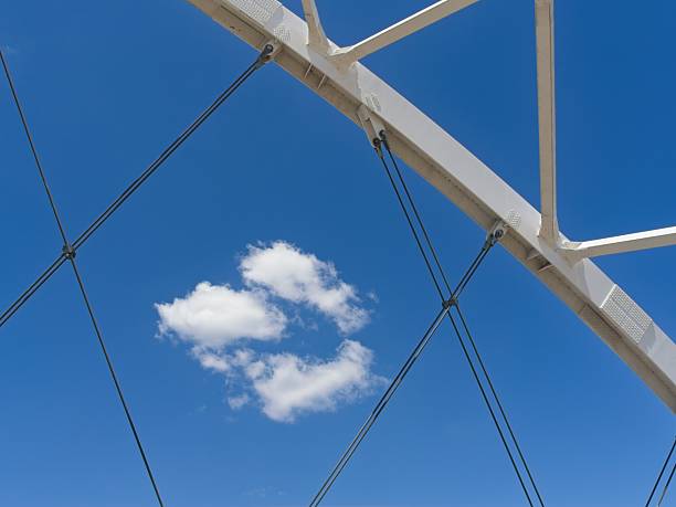 istock Abstract of arch bridge cables and cumulus clouds 2220635458