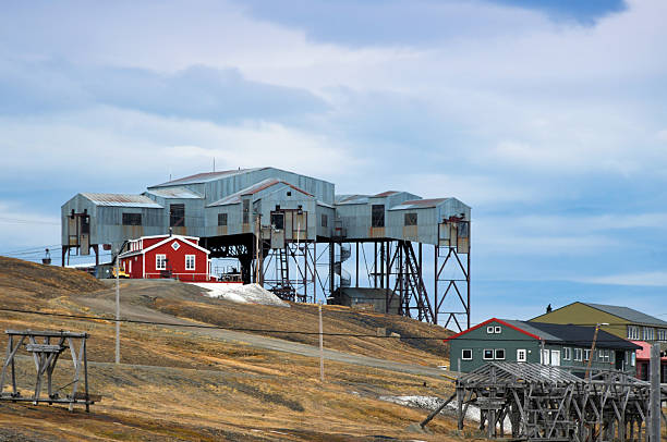 Longyearbyen, Spitsbergen, Svalbard and Jan Mayen Islands, Norway: the Taubanesentrale building (Cableway Central), often called the Spider, is a historic structure that served as the central station for the aerial ropeway system used to transport coal from nearby mines to the harbor. Built in the 1950s, the building was part of the coal mining infrastructure operated by Store Norske Spitsbergen Kulkompani. The system consisted of a network of cableways supported by wooden towers, facilitating efficient coal movement across the rugged Arctic terrain. Though no longer in operation, the Taubanesentrale remains a prominent landmark and a symbol of Longyearbyen’s industrial past, preserved as part of the town’s cultural heritage.