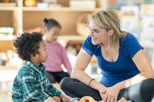 istock Preschool Teacher Interacting with Children in a Bright, Engaging Classroom Setting 2220635738