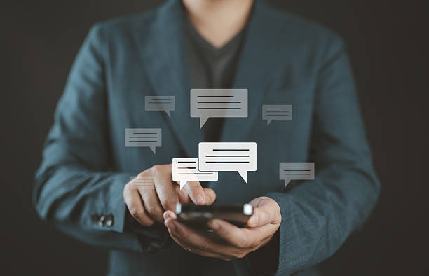 istock Businessman typing on mobile smartphone chatting conversation in chat box icon pop up for social media marketing technology concept. Live Chat on application. 2220635797