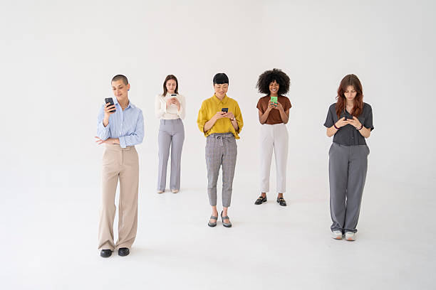 istock Five young businesswomen using their smartphones on white background 2220639976