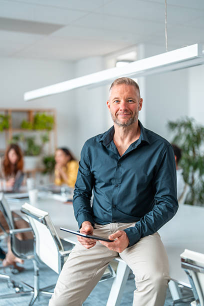 istock Confident Business Executive with Tablet in Boardroom 2220641236