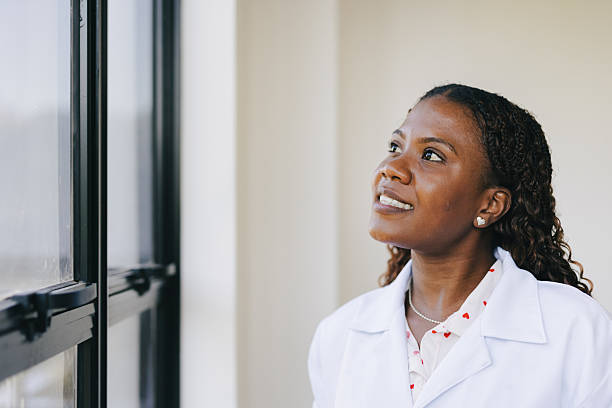istock Female healthcare professional standing by window 2220645461