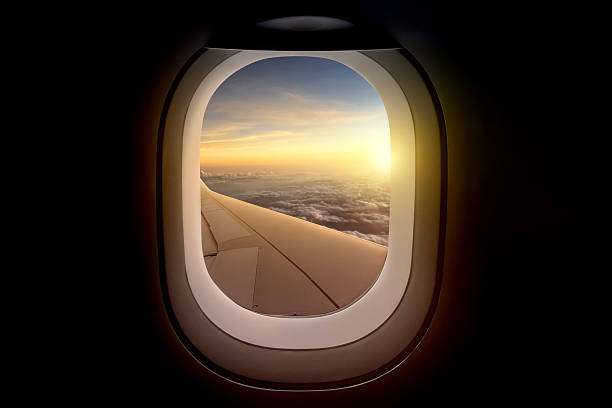 istock Airplane wing view from plane window over the landscape in sunlight. Summer background 2220646946