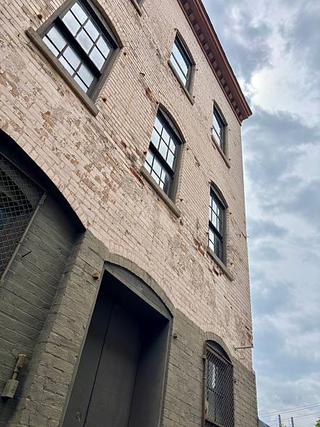 istock 19th century brick building with arched windows under a cloudy sky 2220649543