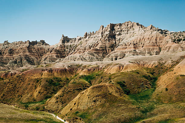 istock Layered rock formations and green slopes at Yellow Mounds, Badlands 2220650089