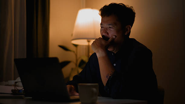 istock Stressed and Sleepy Asian Man Trying to Work Late. 4k. 2220656270