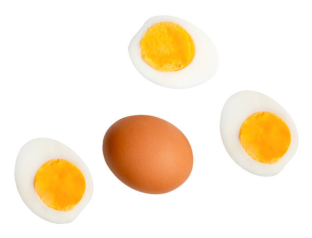 istock Top view set of raw brown chicken egg and cooked or boiled chicken eggs with egg yolk in three halves isolated on white background with clipping path 2220658267