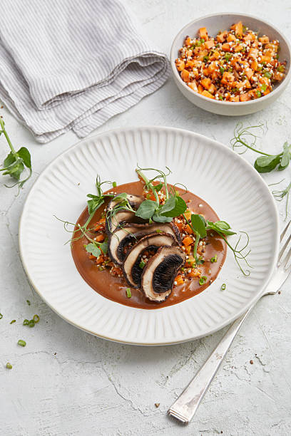 istock Vegan portobello almond steak with brown sauce on white plate 2220659708