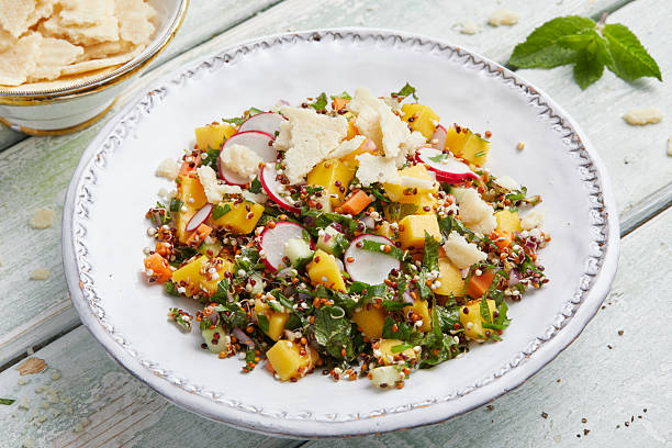 istock Tabbouleh with macadamia, mango and radishes on a white plate 2220660035