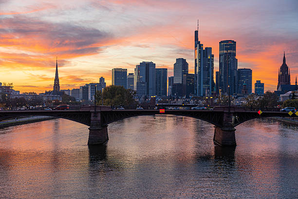 istock Frankfurt skyline reflecting in main river at sunset with bridge 2220660937