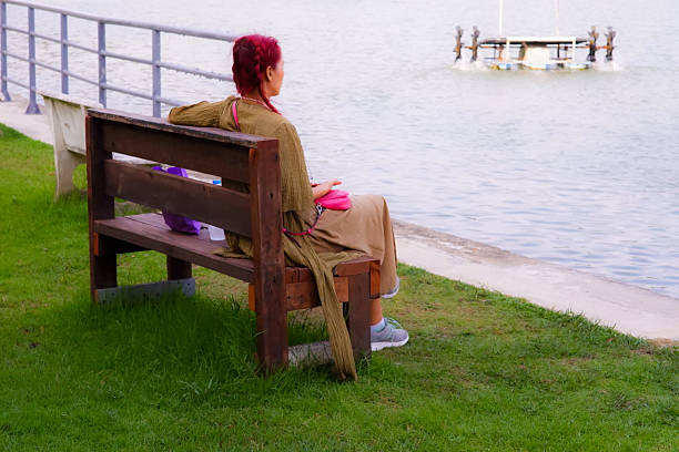 istock A woman sits on a bench enjoying the view. 2220661236
