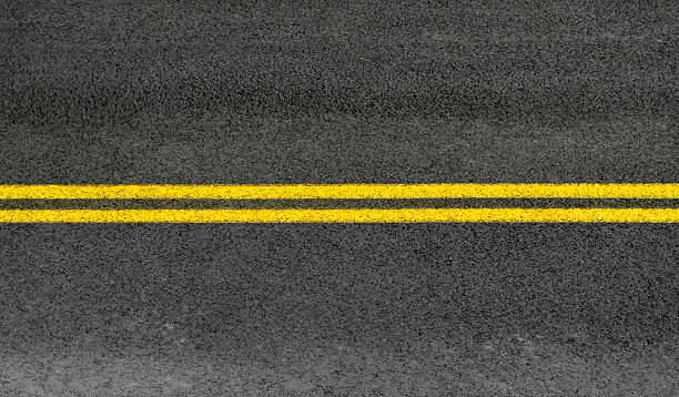 istock double yellow line on the road surface 2220662127