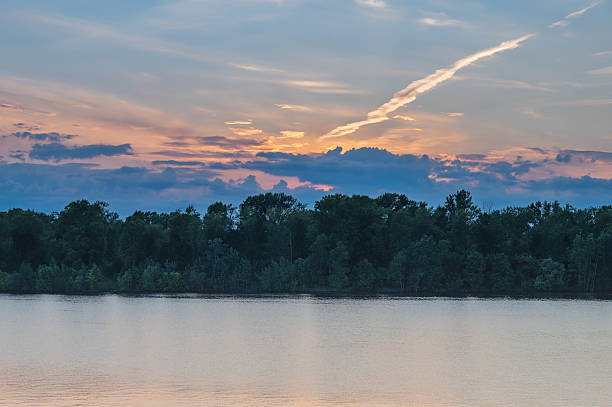 istock Sunset landscape with river and forest on far riverbank. 2220663589