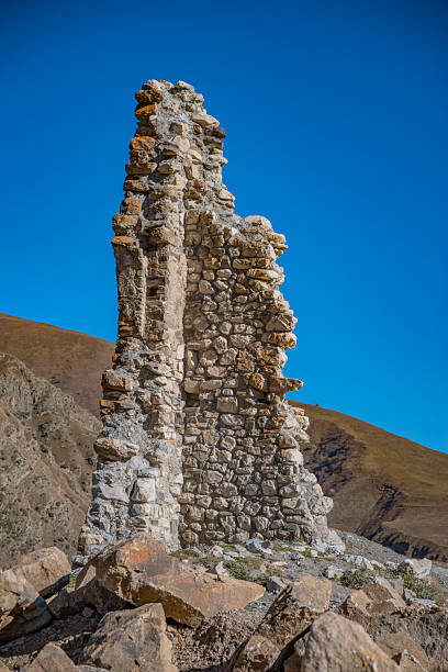 medieval tower against the backdrop of the Caucasus Mountains