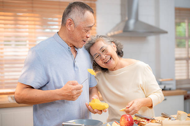 istock Elderly couple enjoys cooking together in their cozy kitchen while sharing laughter and kindness during a sunny afternoon 2220666528