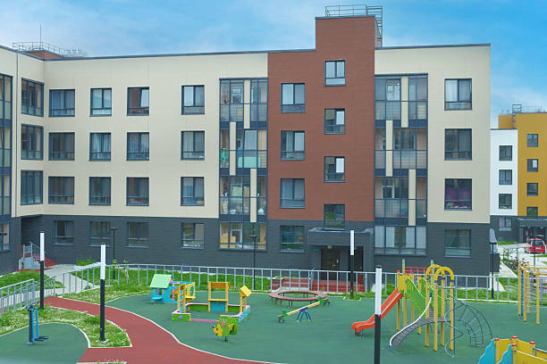 Modern Apartment Building with Colorful Playground..
